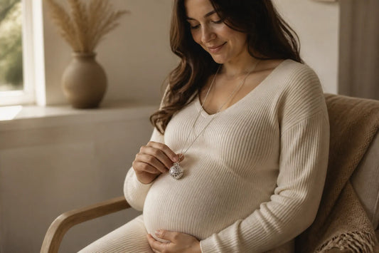 Femme enceinte portant un bola en argent posé sur son ventre