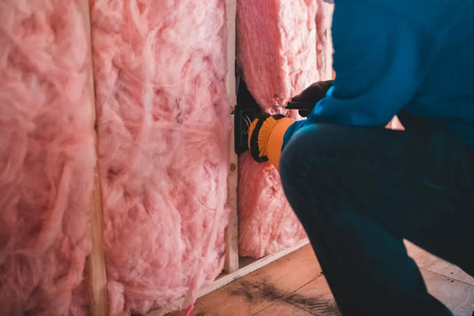 Pose d'un isolant thermique dans un mur lors d'une rénovation énergétique